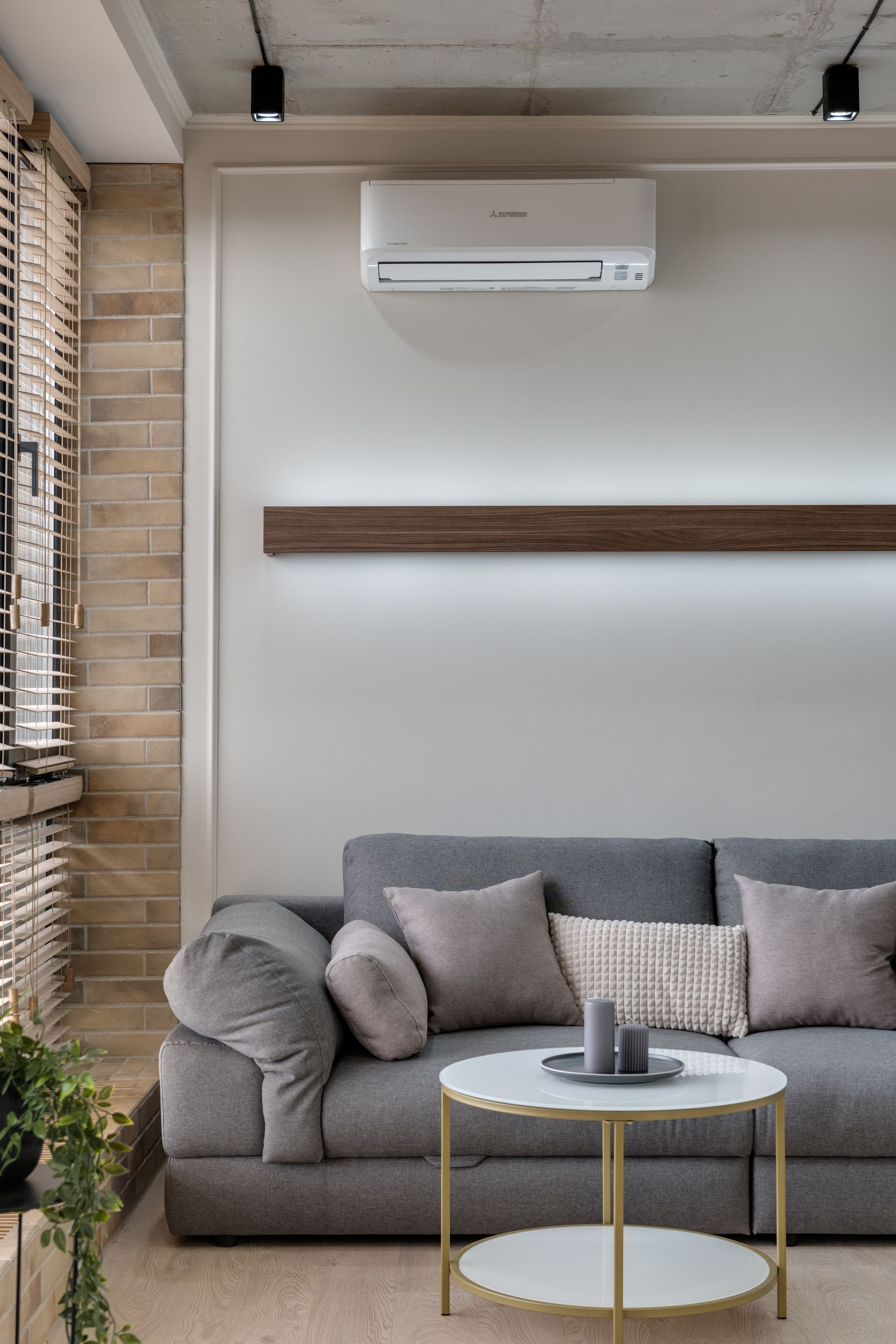 Sofa area with a fitted split air conditioning unit